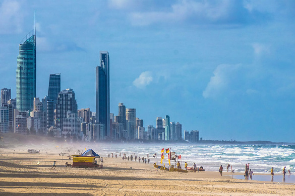 A packed beach with swimmers and lifeguards on the Gold Coast, Queensland